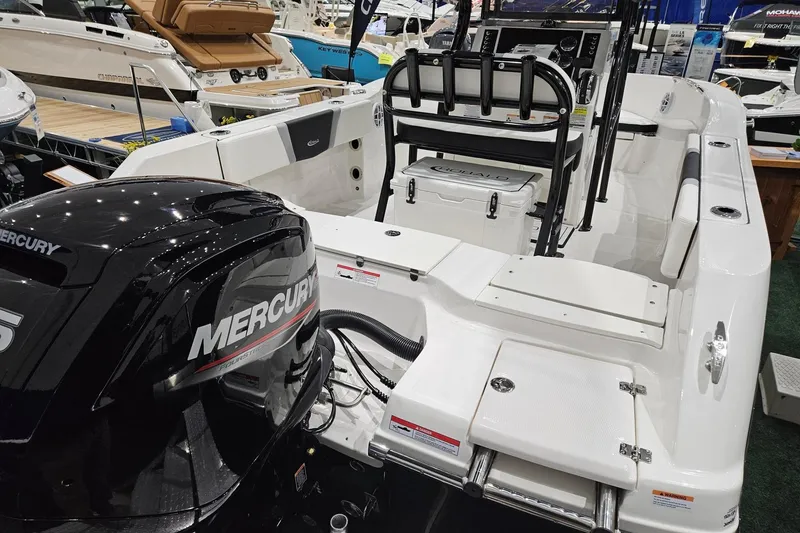 Slide: The Image of 2025 Robalo R180 Center Console boat with Mercury engine, showcased at a boat exhibition. - 14