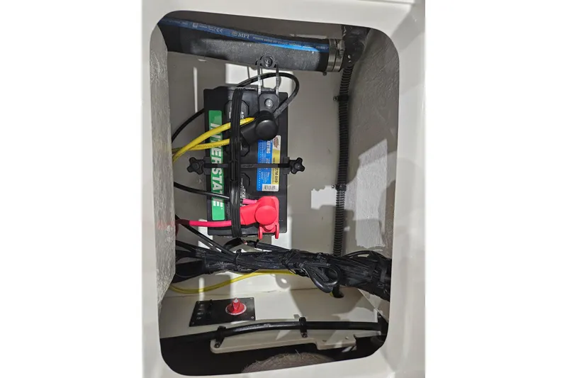 Slide: The Image of 2025 Robalo R180 Center Console battery compartment with wiring and connections. - 15