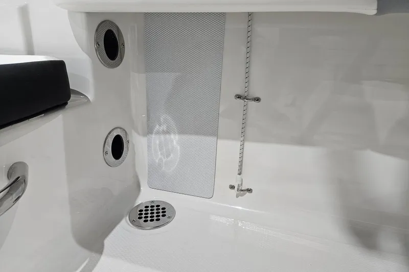 Slide: The Image of 2025 Robalo R180 Center Console interior detail with drainage and seating features. - 17