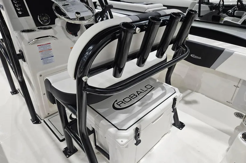 Slide: The Image of 2025 Robalo R180 Center Console boat interior with rod holders and seating. - 18