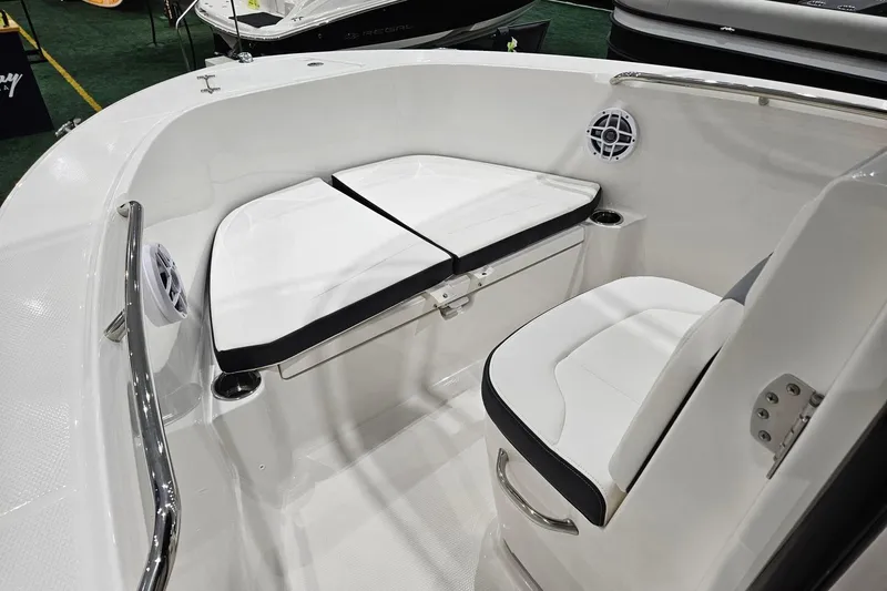 Slide: The Image of 2025 Robalo R180 Center Console boat interior with cushioned seating and stainless steel railings. - 20