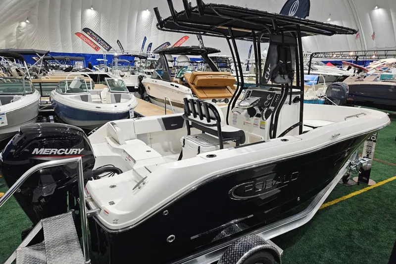 Slide: The Image of 2025 Robalo R180 Center Console boat with Mercury engine at indoor boat show. - 3