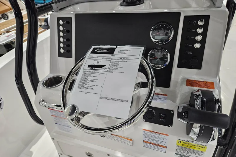 Slide: The Image of 2025 Robalo R180 Center Console boat dashboard with steering wheel and control panel. - 4