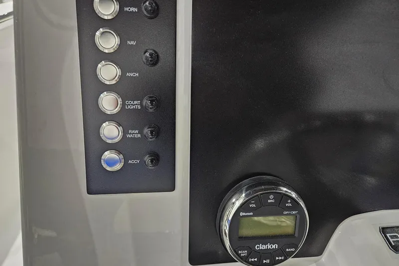 Slide: The Image of Control panel of 2025 Robalo R180 Center Console with buttons and Clarion audio system. - 9