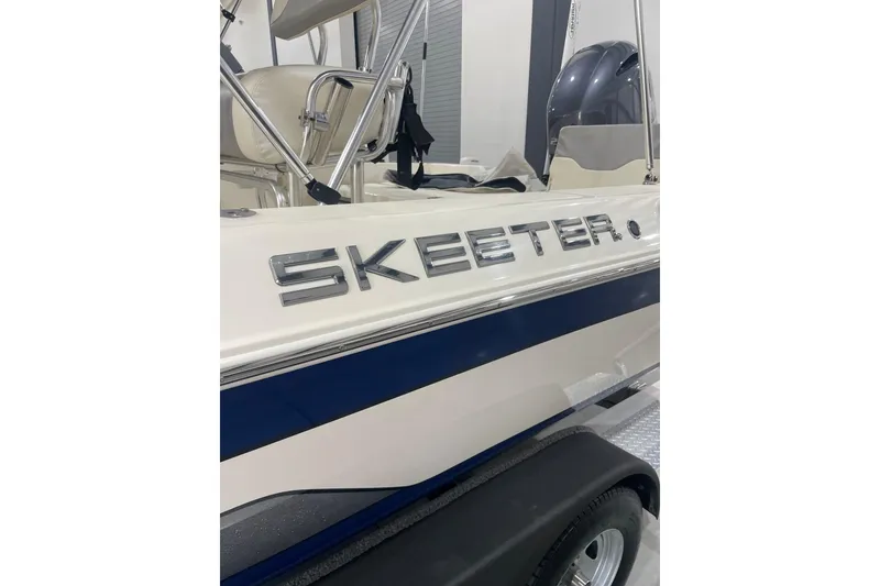Slide: The Image of 2015 Skeeter SX2250 boat with sleek design and chrome logo. - 11