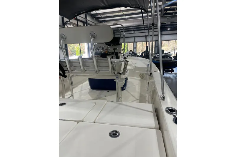 Slide: The Image of 2015 Skeeter SX2250 boat interior with seating and storage, displayed indoors. - 12