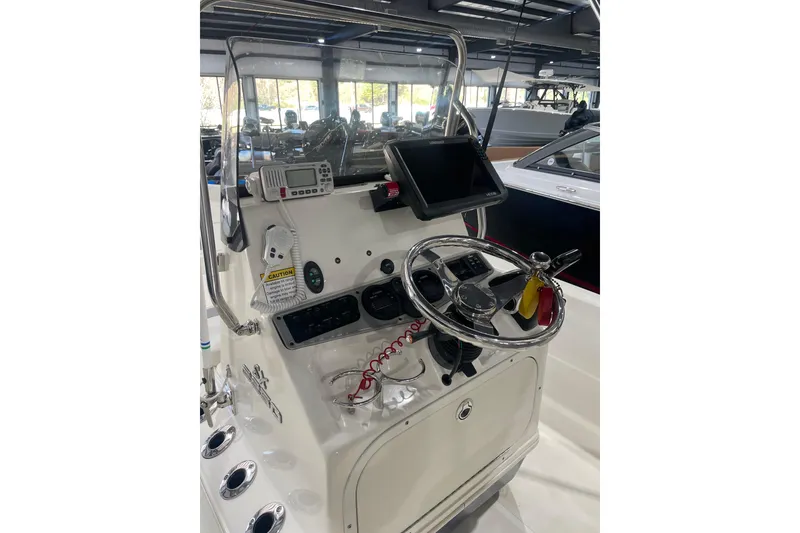 Slide: The Image of 2015 Skeeter SX2250 boat console with steering wheel and navigation equipment. - 13