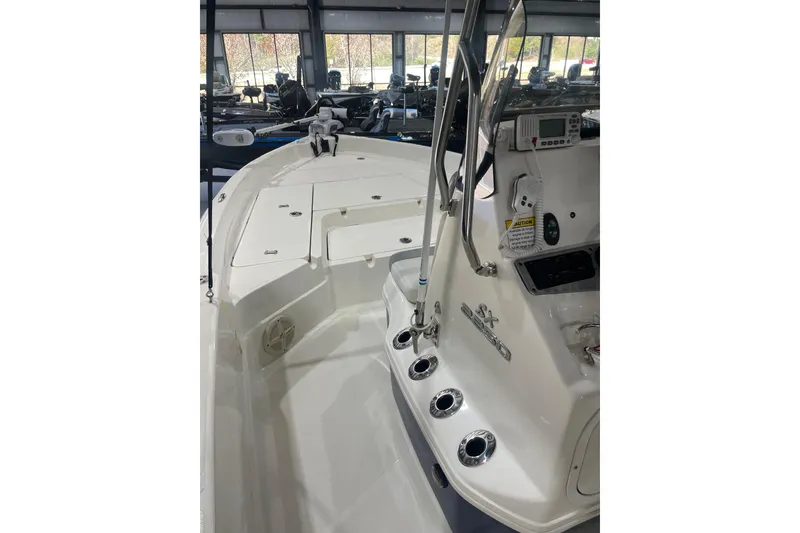Slide: The Image of 2015 Skeeter SX2250 boat interior with fishing rod holders and control panel. - 16