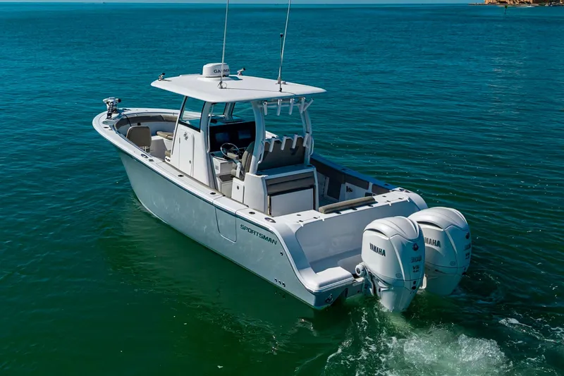 Slide: The Image of 2023 Sportsman Open 302 Center Console boat on clear blue water. - 11