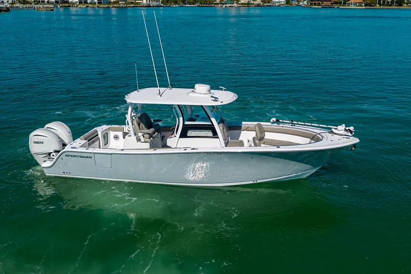 Slide: The Image of 2023 Sportsman Open 302 Center Console boat on clear blue water. - 13
