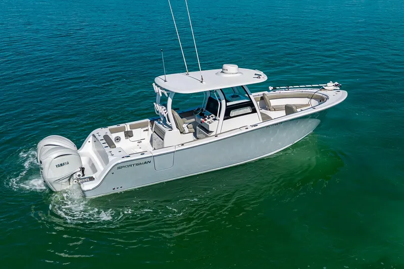 Slide: The Image of 2023 Sportsman Open 302 Center Console boat cruising on clear blue water. - 15