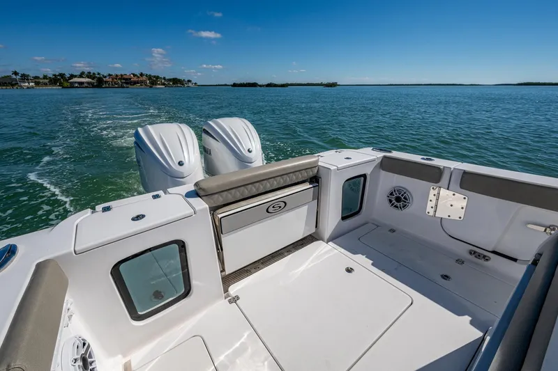 Slide: The Image of 2023 Sportsman Open 302 Center Console boat on open water, featuring dual engines. - 22