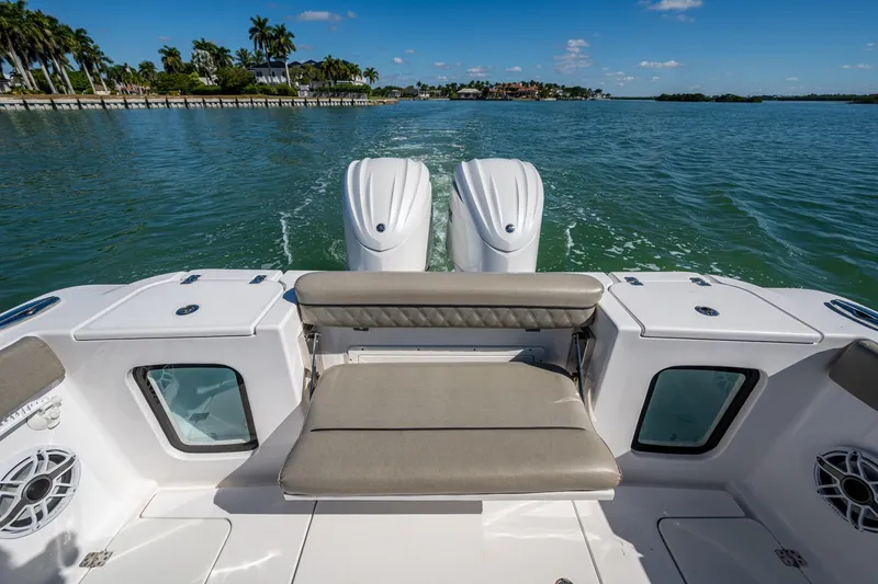 Slide: The Image of 2023 Sportsman Open 302 Center Console boat on water, featuring dual engines and seating. - 25