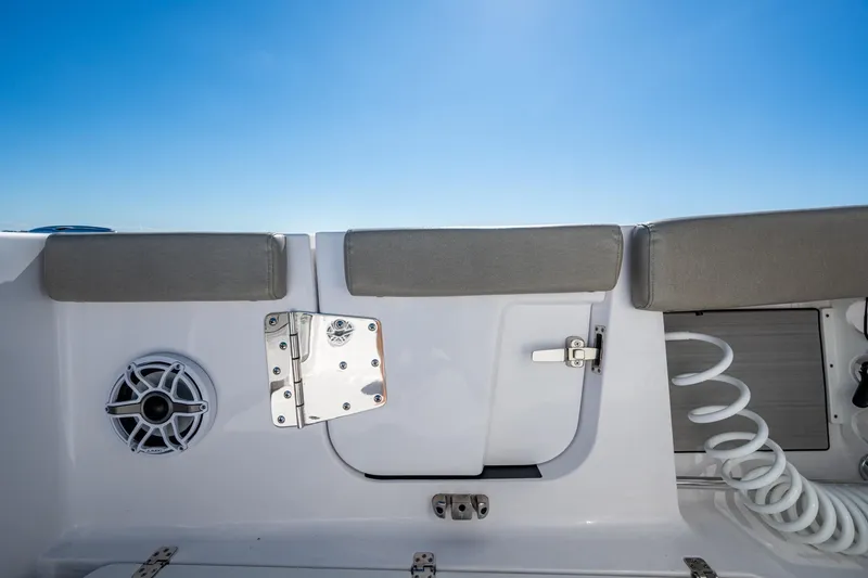Slide: The Image of 2023 Sportsman Open 302 Center Console boat interior with speaker and storage compartment. - 27
