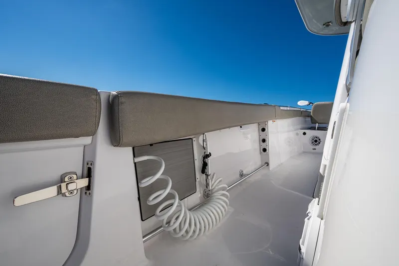 Slide: The Image of 2023 Sportsman Open 302 Center Console boat interior with sleek design and blue sky. - 28