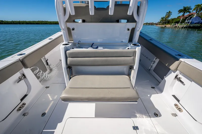 Slide: The Image of 2023 Sportsman Open 302 Center Console boat interior with seating, on a sunny day. - 31