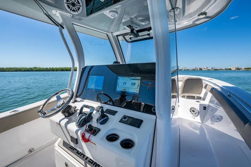 Slide: The Image of 2023 Sportsman Open 302 Center Console boat interior with modern controls and scenic water view. - 36