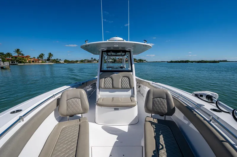 Slide: The Image of 2023 Sportsman Open 302 Center Console boat on calm water, featuring luxurious seating. - 43