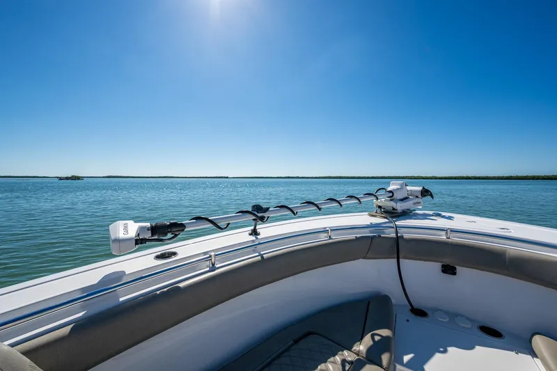 Slide: The Image of 2023 Sportsman Open 302 Center Console on calm water under clear blue sky. - 46