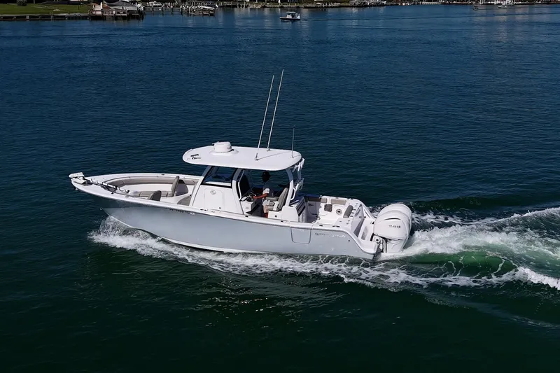 Slide: The Image of 2023 Sportsman Open 302 Center Console boat cruising on calm water. - 50