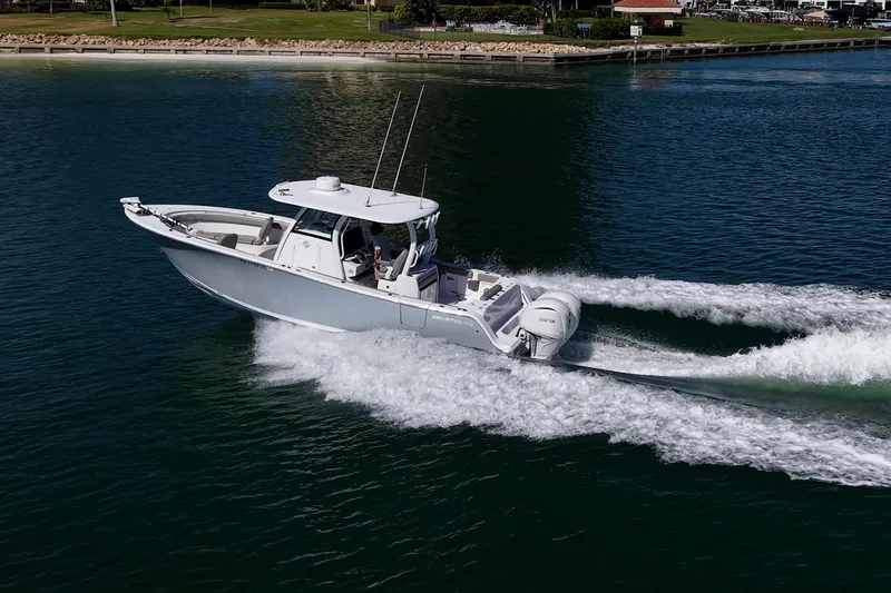 Slide: The Image of 2023 Sportsman Open 302 Center Console boat cruising on water. - 51