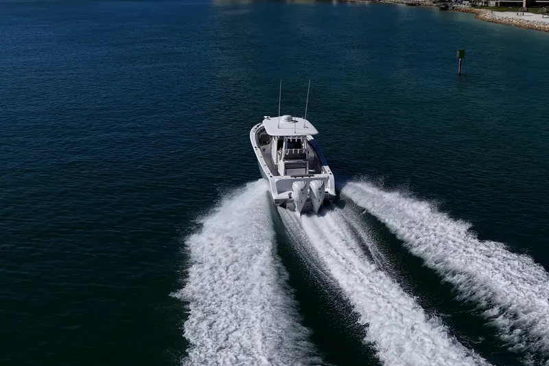 Slide: The Image of 2023 Sportsman Open 302 Center Console boat cruising on open water. - 54