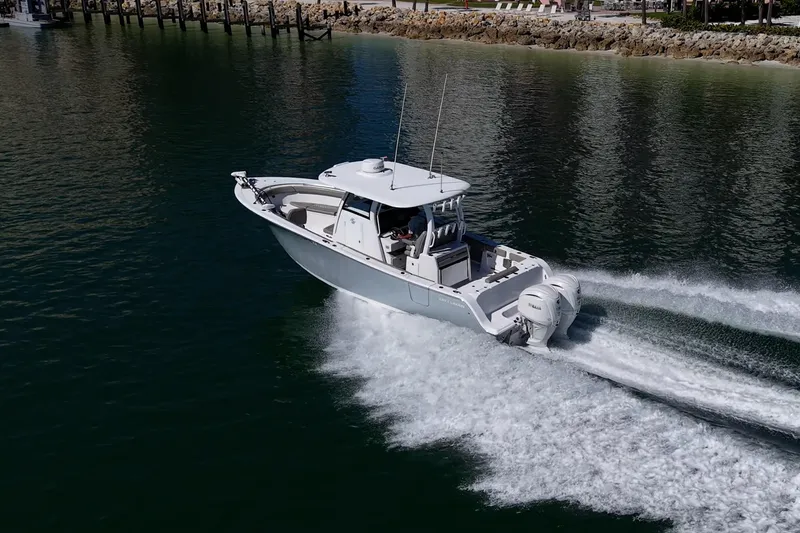 Slide: The Image of 2023 Sportsman Open 302 Center Console boat cruising on water. - 60