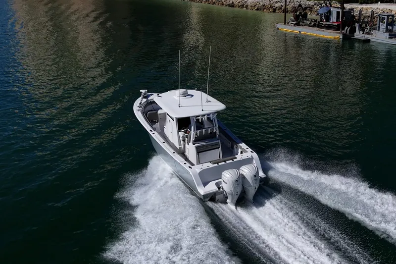 Slide: The Image of 2023 Sportsman Open 302 Center Console boat cruising on water. - 61