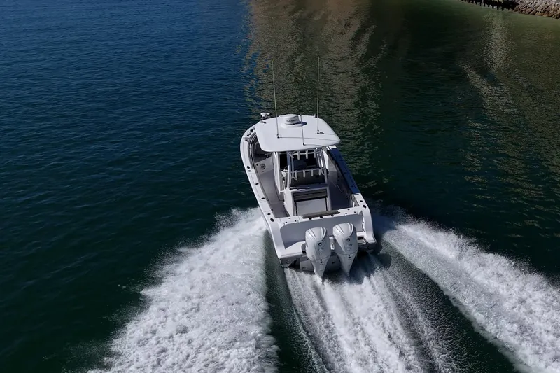 Slide: The Image of 2023 Sportsman Open 302 Center Console cruising on open water, rear view. - 62