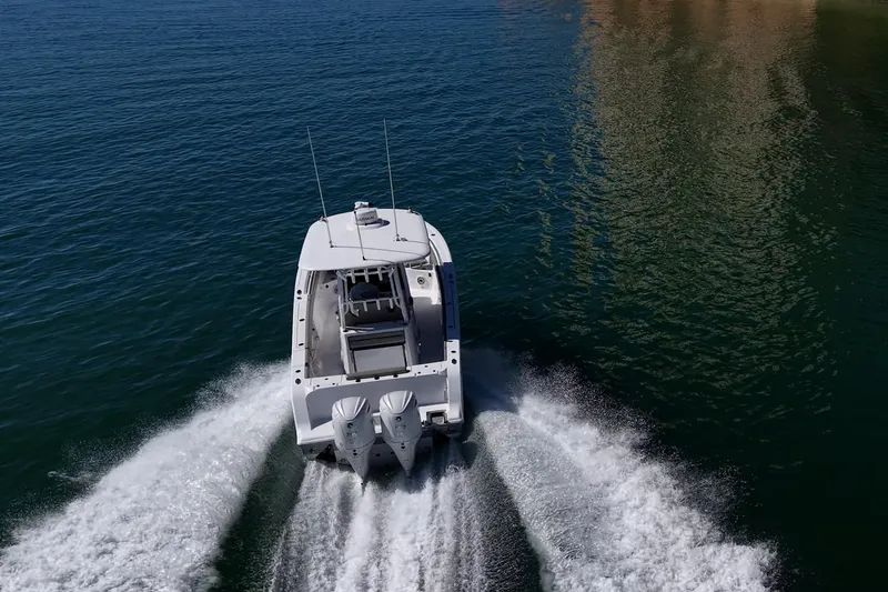 Slide: The Image of 2023 Sportsman Open 302 Center Console boat cruising on open water. - 63