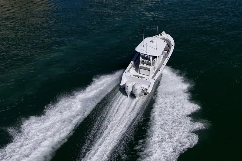 Slide: The Image of 2023 Sportsman Open 302 Center Console boat cruising on open water. - 66