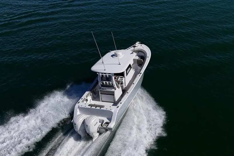 Slide: The Image of 2023 Sportsman Open 302 Center Console boat cruising on open water. - 72