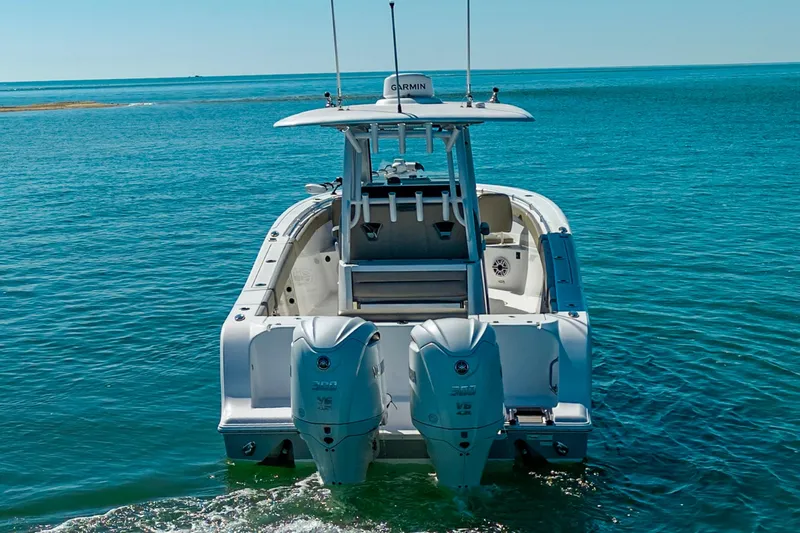 Slide: The Image of 2023 Sportsman Open 302 Center Console boat on clear blue water. - 9
