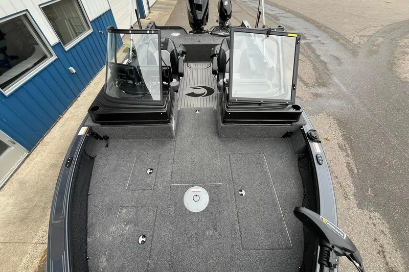 Slide: The Image of 2025 Crestliner 2050 Fish Hawk boat interior with dual consoles and spacious deck. - 13