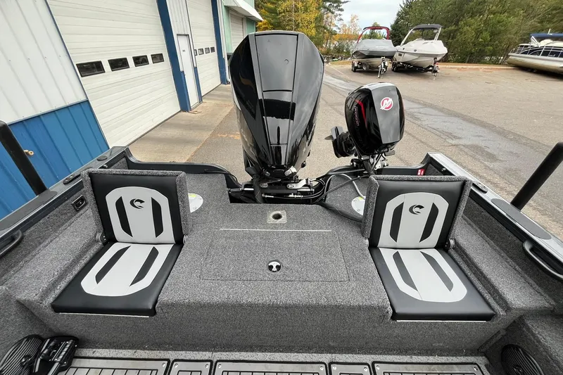 Slide: The Image of 2025 Crestliner 2050 Fish Hawk boat interior with dual seats and powerful outboard motors. - 17