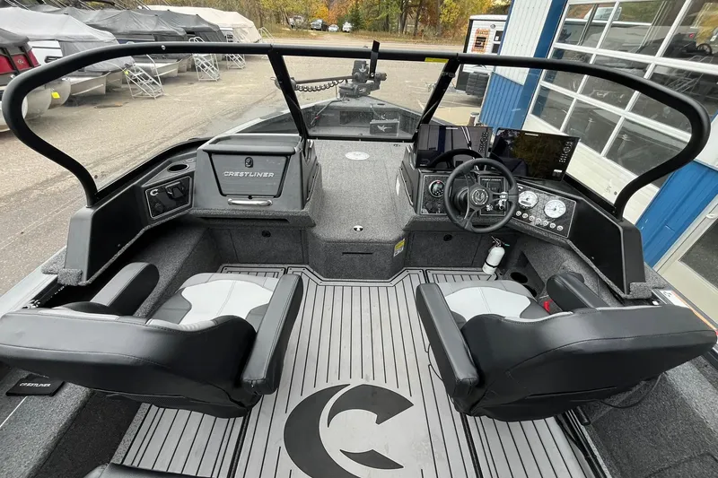 Slide: The Image of 2025 Crestliner 2050 Fish Hawk boat interior with dual seats and modern dashboard. - 7