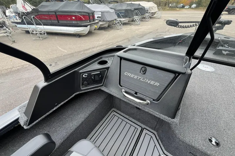 Slide: The Image of 2025 Crestliner 2050 Fish Hawk boat interior with storage compartment and seating. - 8