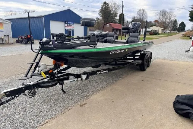 Slide: The Image of 2024 Falcon Boats F195 on trailer, parked outdoors near blue building. - 12