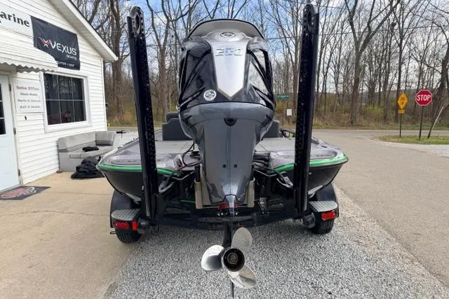 Slide: The Image of 2024 Falcon Boats F195 with powerful outboard motor, parked near a marine shop. - 5