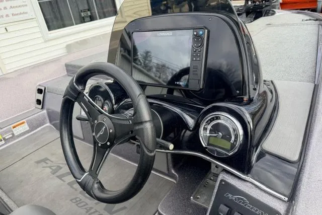 Slide: The Image of 2024 Falcon Boats F195 dashboard with steering wheel and navigation display. - 6