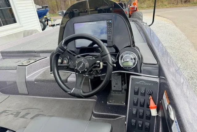 Slide: The Image of 2024 Falcon Boats F195 dashboard with steering wheel and navigation system. - 7