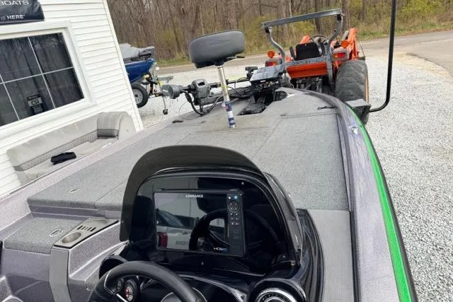 Slide: The Image of 2024 Falcon Boats F195 with advanced navigation system, parked near a tractor. - 8