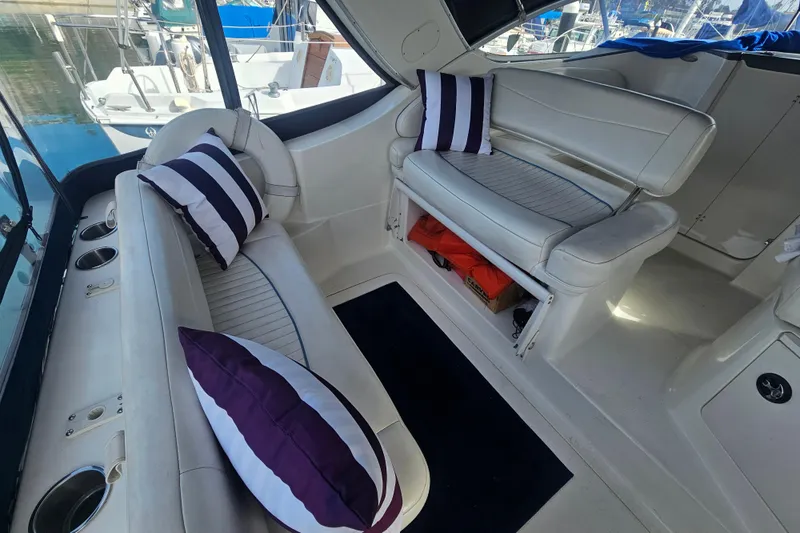 Slide: The Image of Interior of 2005 Bayliner 2855 Ciera with white seating and striped cushions. - 10