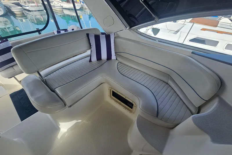 Slide: The Image of Luxurious seating area on a 2005 Bayliner 2855 Ciera boat with striped cushions. - 12