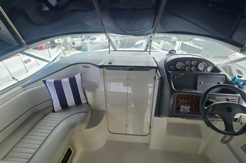 Slide: The Image of 2005 Bayliner 2855 Ciera boat interior with steering wheel and seating area. - 16