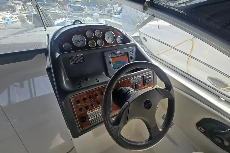 Slide: The Image of 2005 Bayliner 2855 Ciera boat dashboard with steering wheel and navigation instruments. - 17