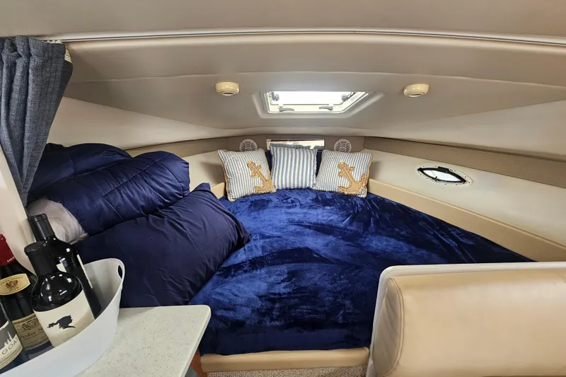 Slide: The Image of Cozy interior of 2005 Bayliner 2855 Ciera with plush bedding and decorative pillows. - 22