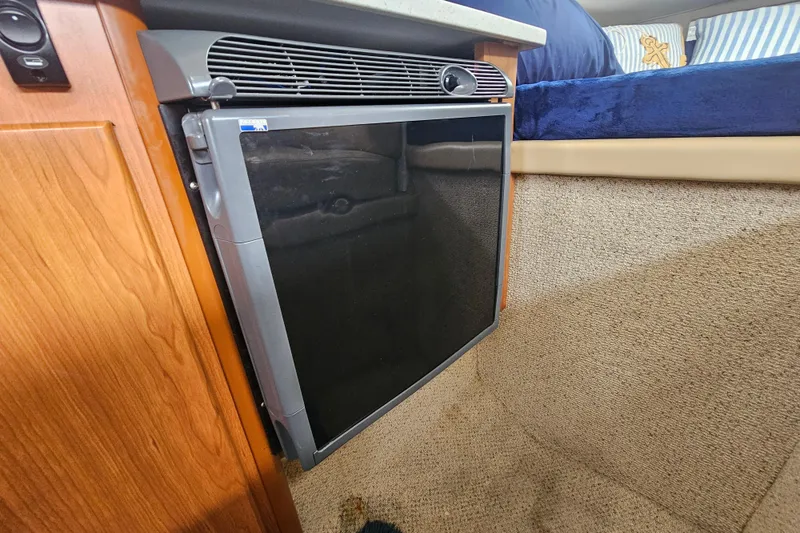 Slide: The Image of 2005 Bayliner 2855 Ciera interior with compact refrigerator and cozy cabin design. - 26