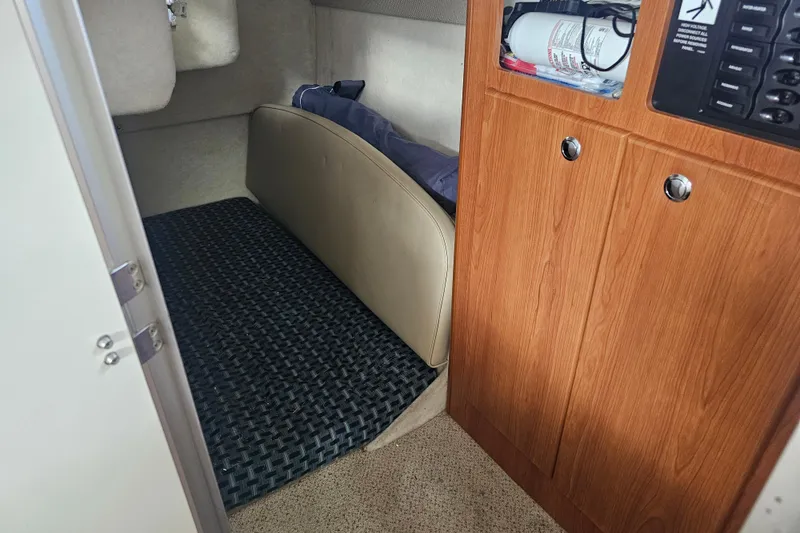 Slide: The Image of Interior cabin of 2005 Bayliner 2855 Ciera boat with wood paneling and storage. - 33
