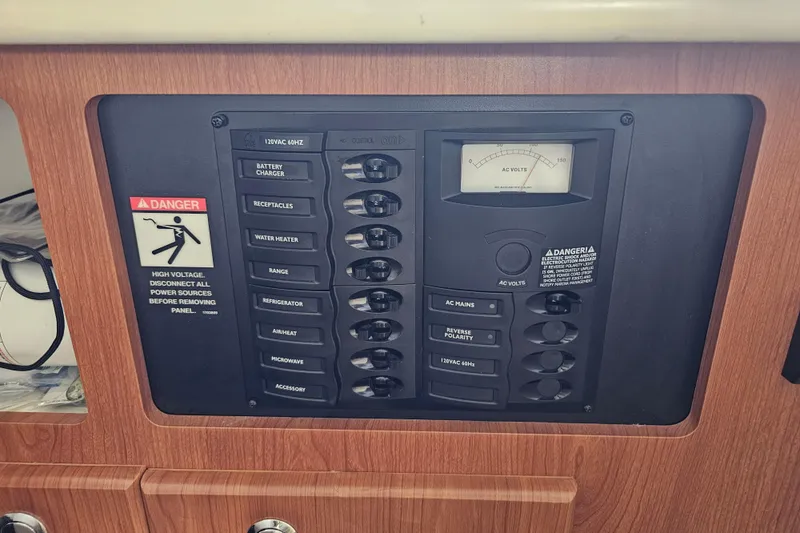 Slide: The Image of Electrical control panel on a 2005 Bayliner 2855 Ciera boat, featuring various switches and voltage meter. - 34